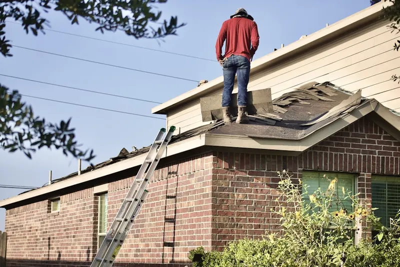 Professional roofer working on a residential roof in Quaker Gardens